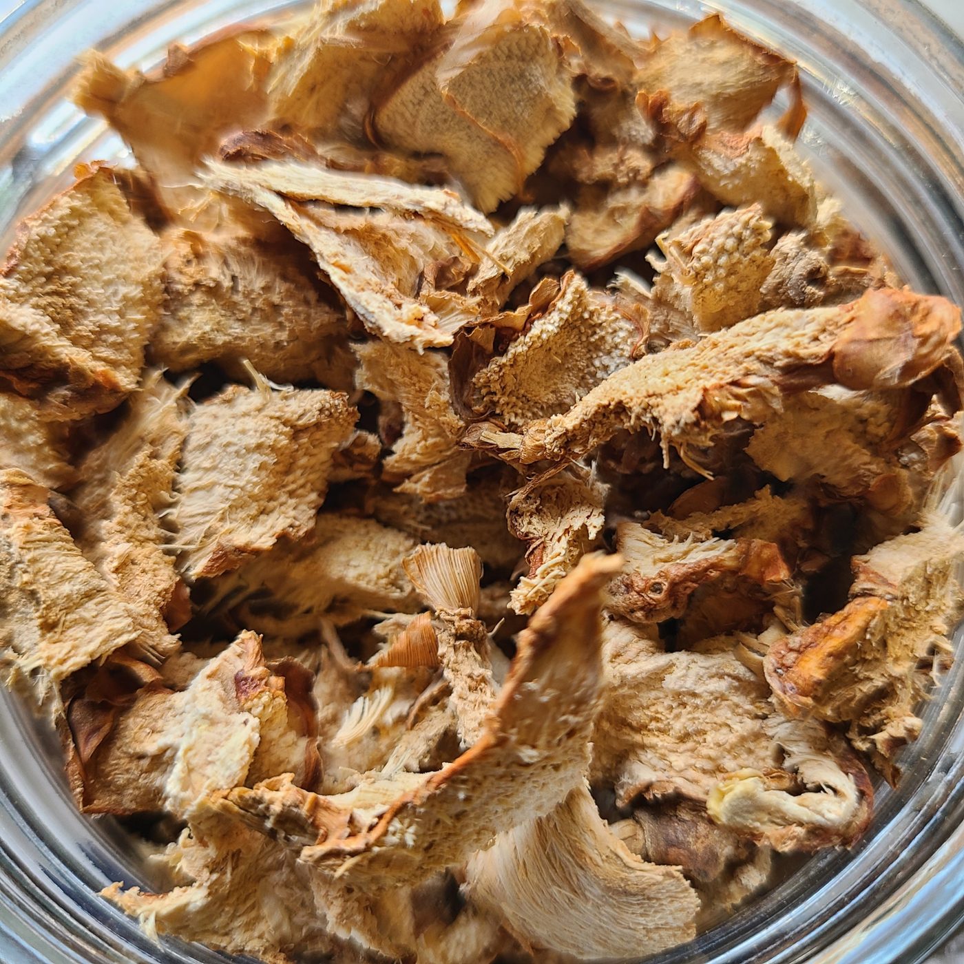 A glass jar full of dried root slices