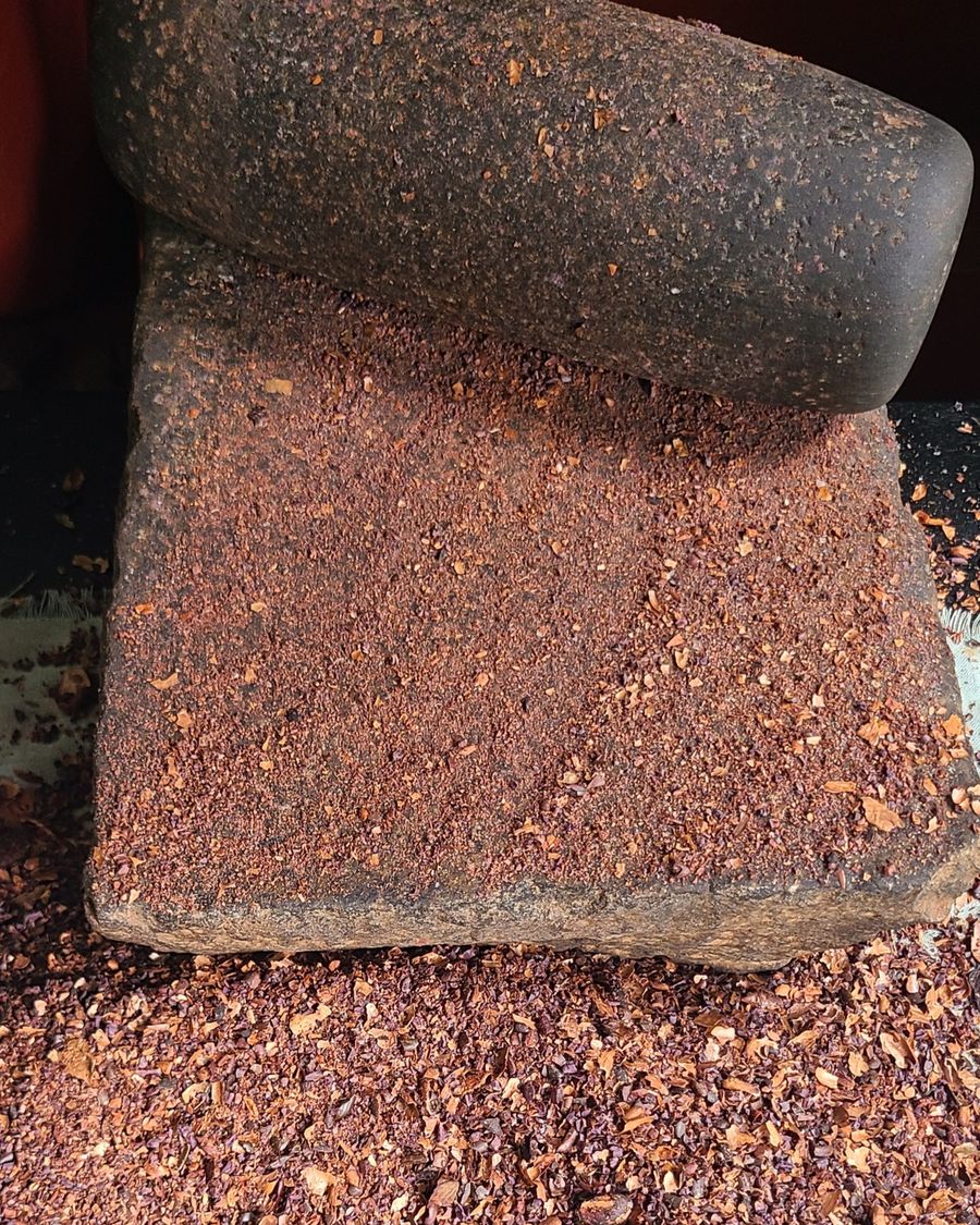 Roasted cacao on a traditional miris gala grinding stone
