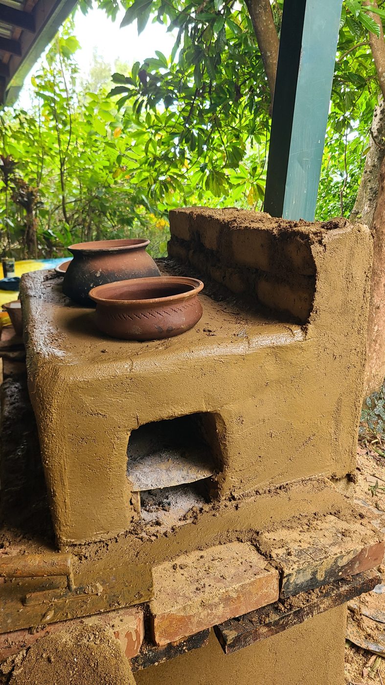 A new clay rocket stove with clay cooking pots on top