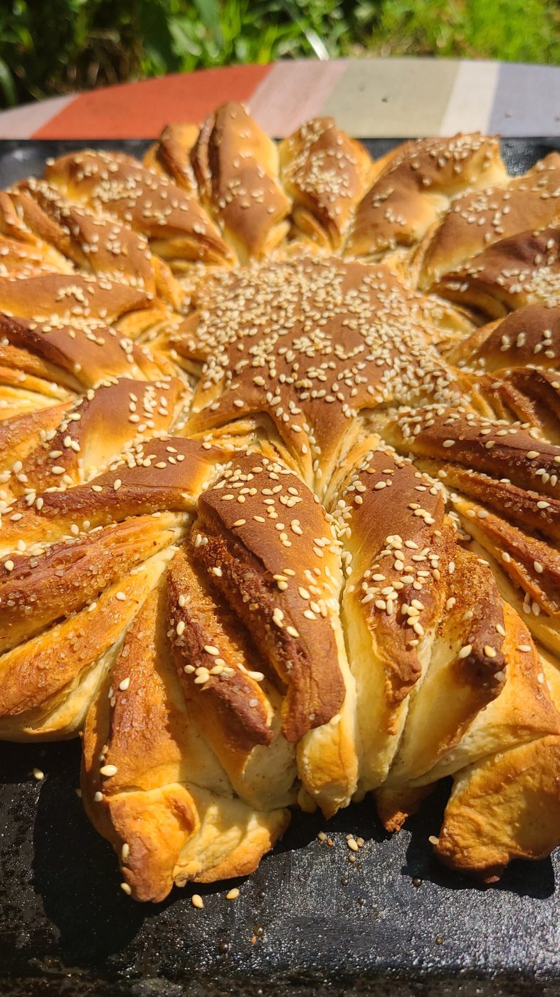 A golden sesame-topped star bread fresh from the oven